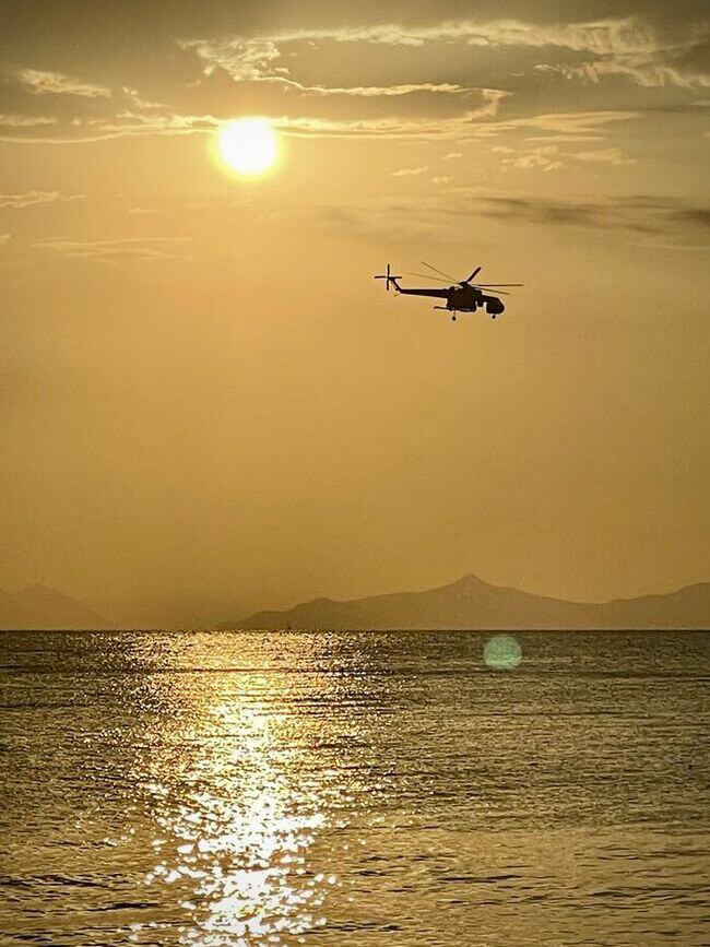 helicopter in the sky during golden hour