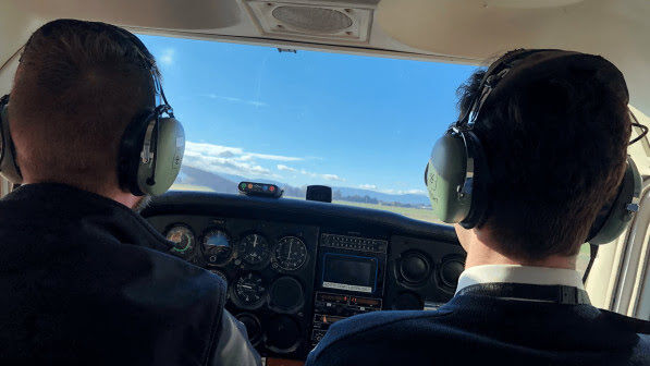 two pilots in plane showing dashboard