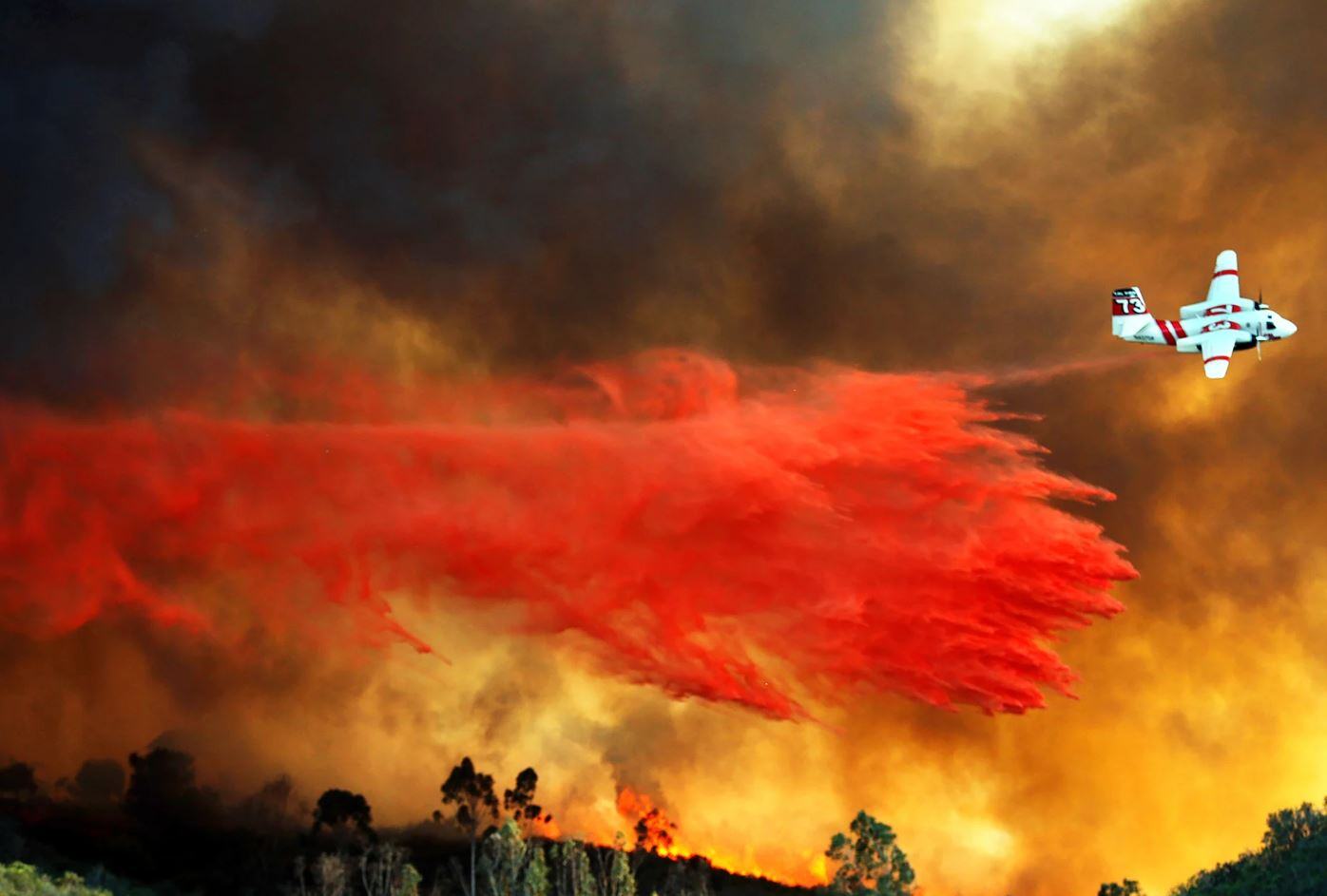 airplane releasing firefighting agent on wildfires