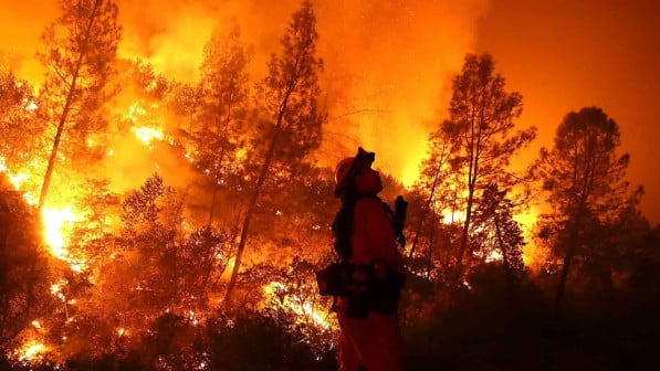 firefighter surrounded by wildfire