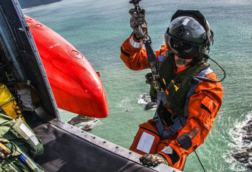 responder preparing to go down helicopter